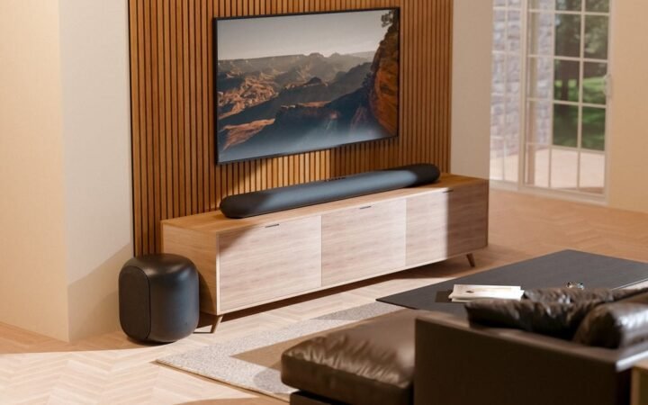 Soundbar Bluesound PULSE CINEMA e subwoofer em uma sala de estar